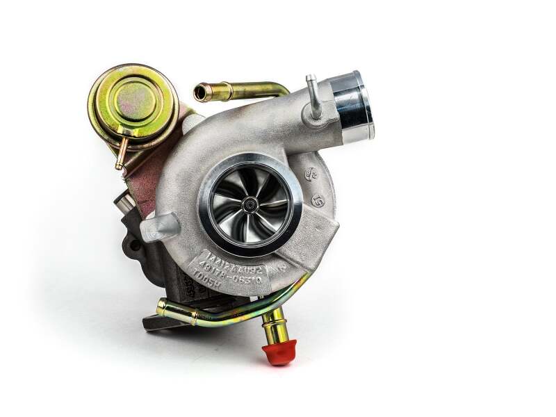 A Subaru STi/WRX blue turbocharger with a 58mm CH8 CM turbine and an oil line.